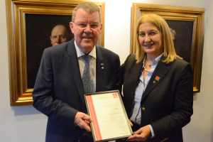 Chryssy Potsiou presents certificate to Henning Elmstroem